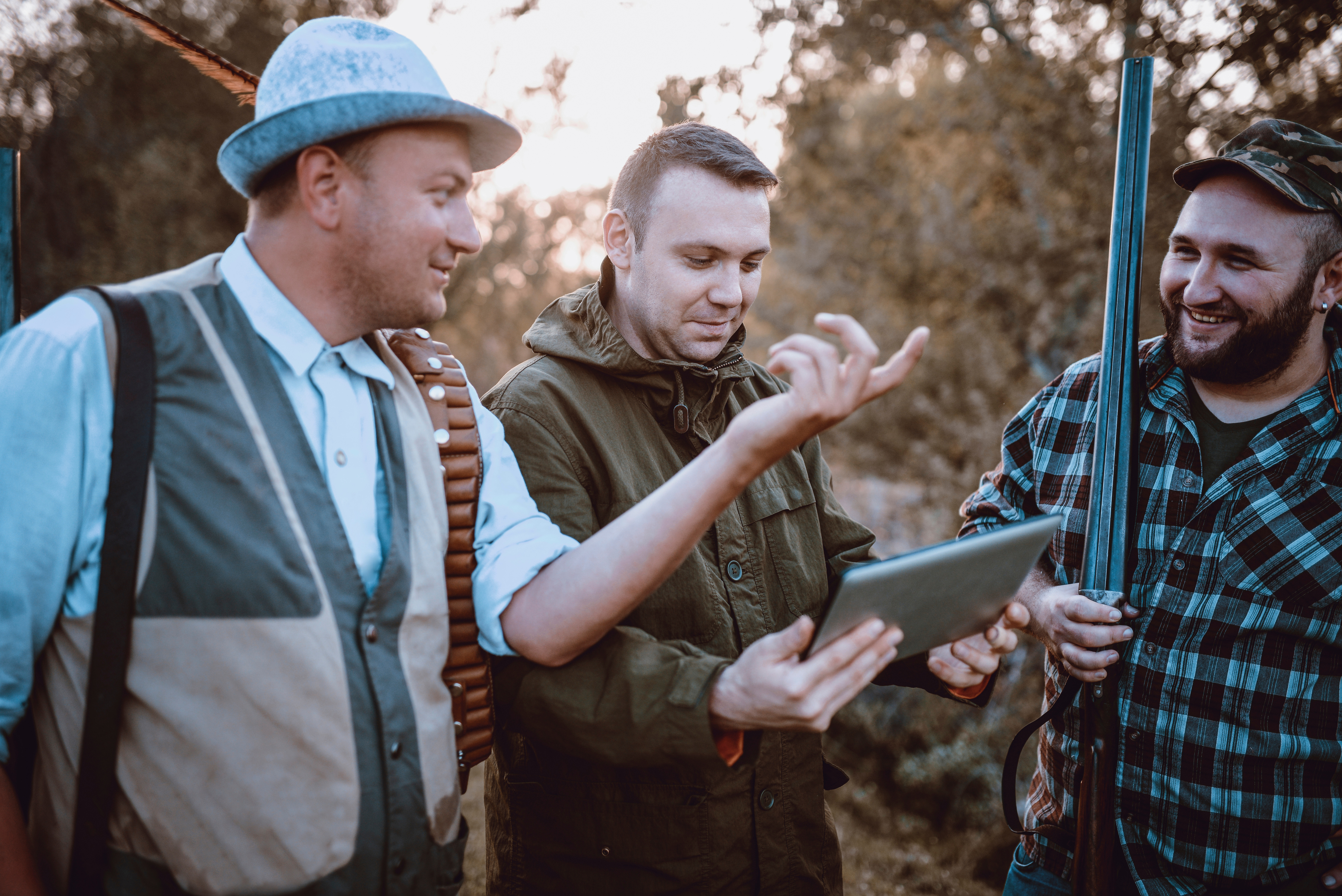 Modern Hunters Looking For Map Direction On Tablet